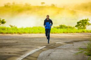 6 Powerful Mental Benefits of Running: How Every Mile Boosts Your Mood & Mental Health man in track suit jogging on concrete road